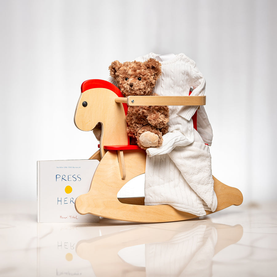 Rock a Bye baby gift with a wooden rocking horse, a plush bear, a blanket and a keepsake card