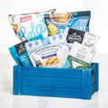 Sans Gluten gluten free gift crate in blue with quinoa brittle, crackers, popcorn and snacks