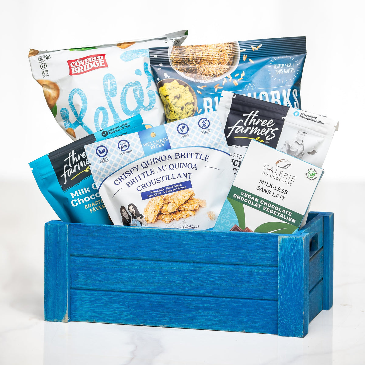 Sans Gluten gluten free gift crate in blue with quinoa brittle, crackers, popcorn and snacks