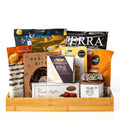 Sans Gluten: a bamboo serving tray with Terra vegetable chips, Castello brie, a Healthy Bites fig and almond cake, fine French truffles, fig jam, Elan coconut and snack crisps