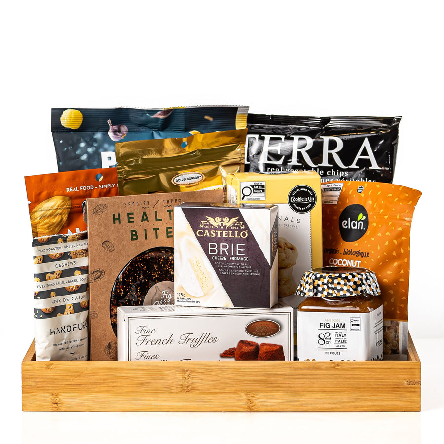 Sans Gluten: a bamboo serving tray with Terra vegetable chips, Castello brie, a Healthy Bites fig and almond cake, fine French truffles, fig jam, Elan coconut and snack crisps