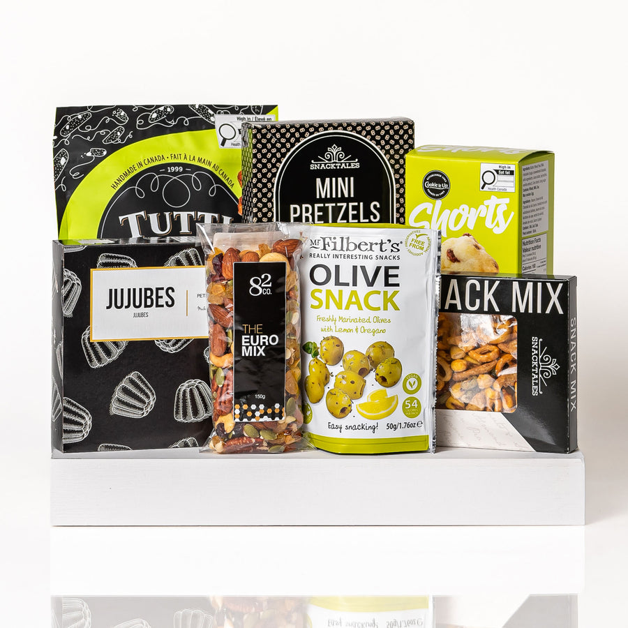 Snack Attack: a white serving tray with jujubes, mini pretzels, Mr Filbert's olive snacks, Co. 82 Euro mix, Snacktales snack mix, Tutti Gourmet biscotti and chocolate chip shorts