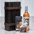 Solo Mio gift with a bottle of rose wine, chocolate and nuts presented against a dark wood crate