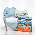 Splish Splash baby boy gift with a blue knitted set, bath toys and the book Into the Ocean