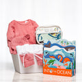 Splish Splash baby girl gift with a pink knitted set, bath toys and the book Into the Ocean