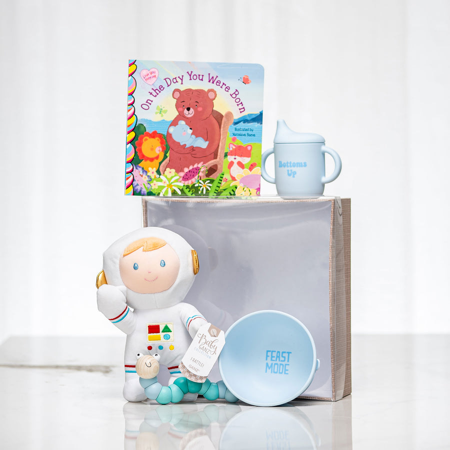 Star Power baby gift with an astronaut plush doll, a board book and a blue sippy cup and bowl