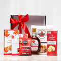 Sweet Stack gift with maple fudge, Jakeman's syrup, pancake mix and cookies tied with a red bow