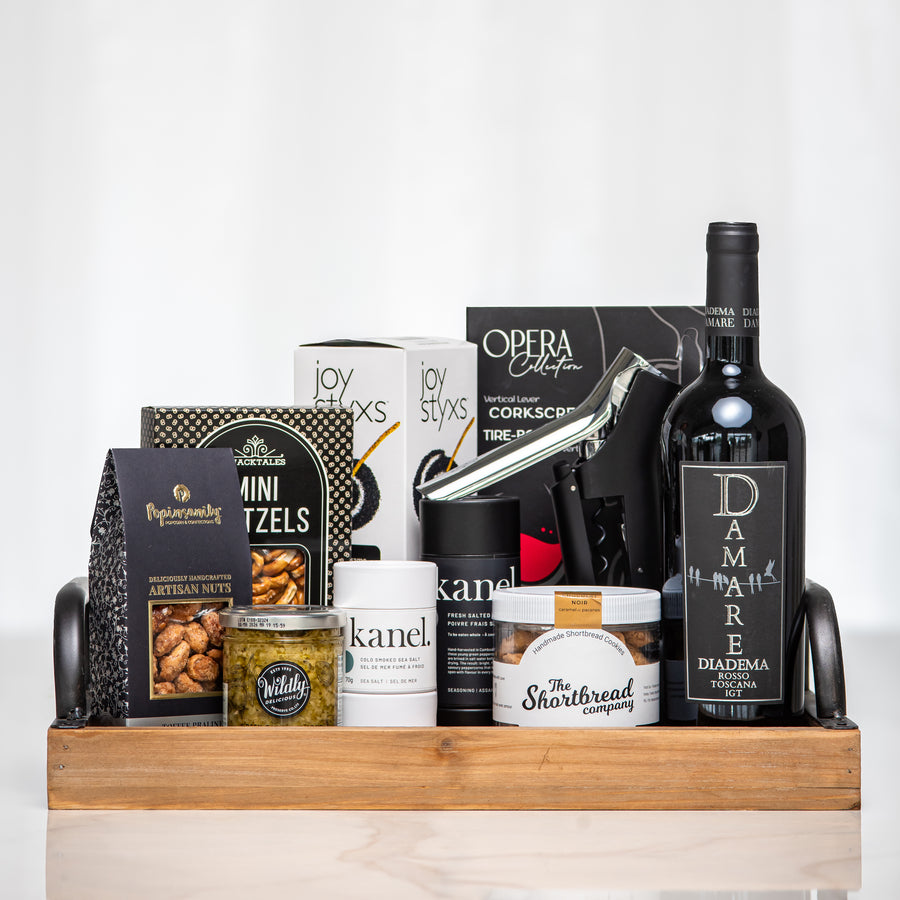 The Entertainer gift tray with a bottle of red wine, pretzels, nuts, cheese and candles