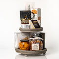 Tiered Treats: a two tier wooden serving stand with Martelli apricot halves, Castello brie, fig jam, Kourabie Greek cookies, Toast for Cheese crackers and caramel cashew popcorn