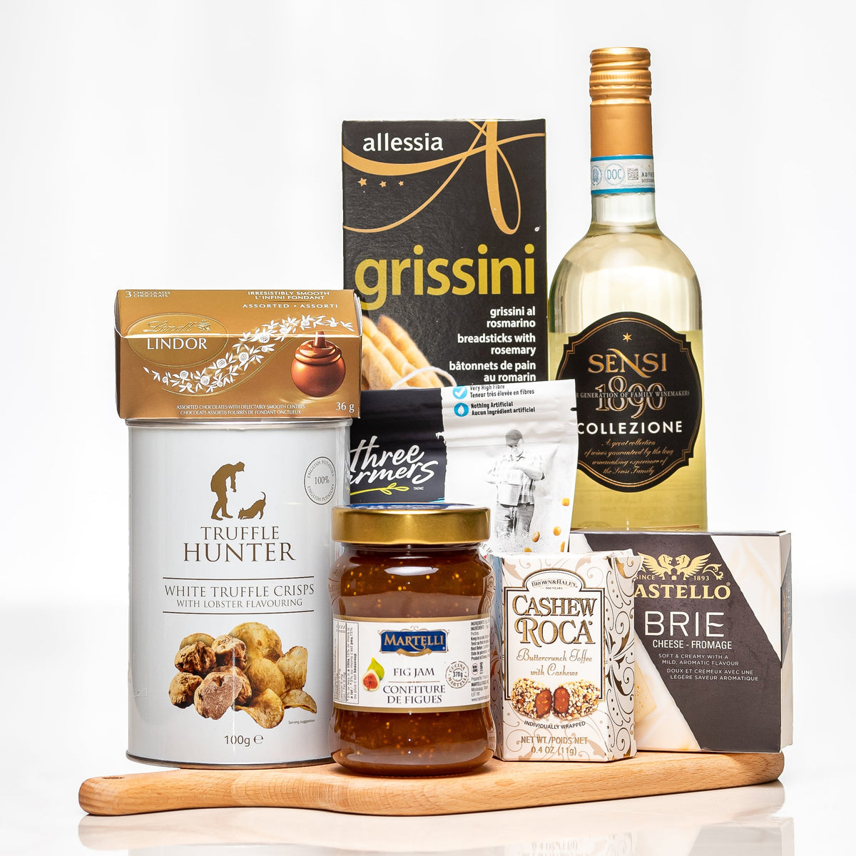Toast and Taste gift with a bottle of white wine, grissini, truffle cream, cashews and brie