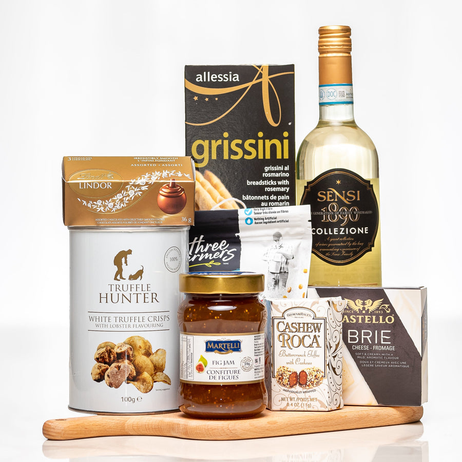 Toast and Taste gift with a bottle of white wine, grissini, truffle cream, cashews and brie