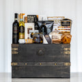 Treasure Trove large dark trunk with two bottles of wine, olive oil, crackers and pretzels