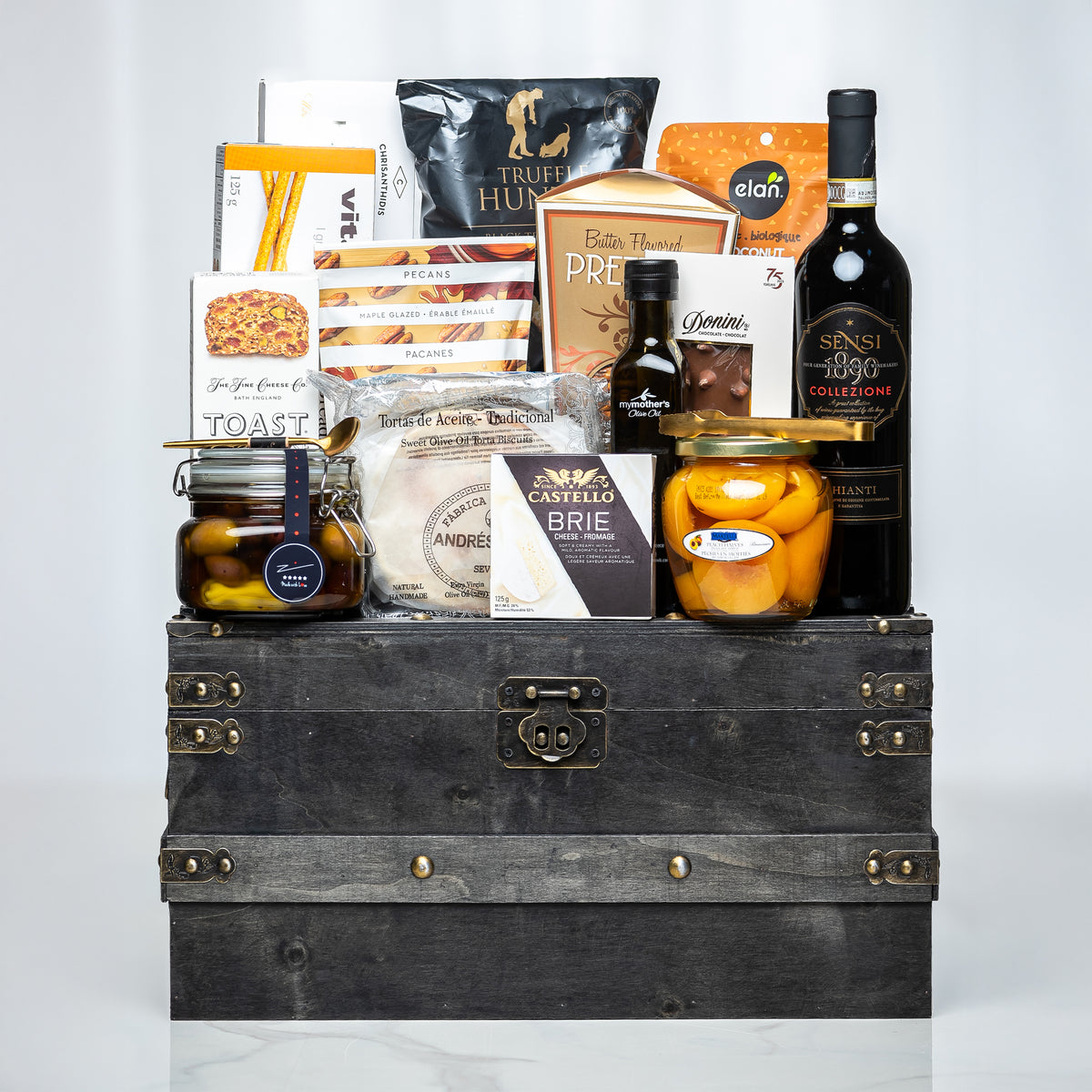Treasure Trove small dark trunk with olive oil, preserves, crackers and gourmet snacks