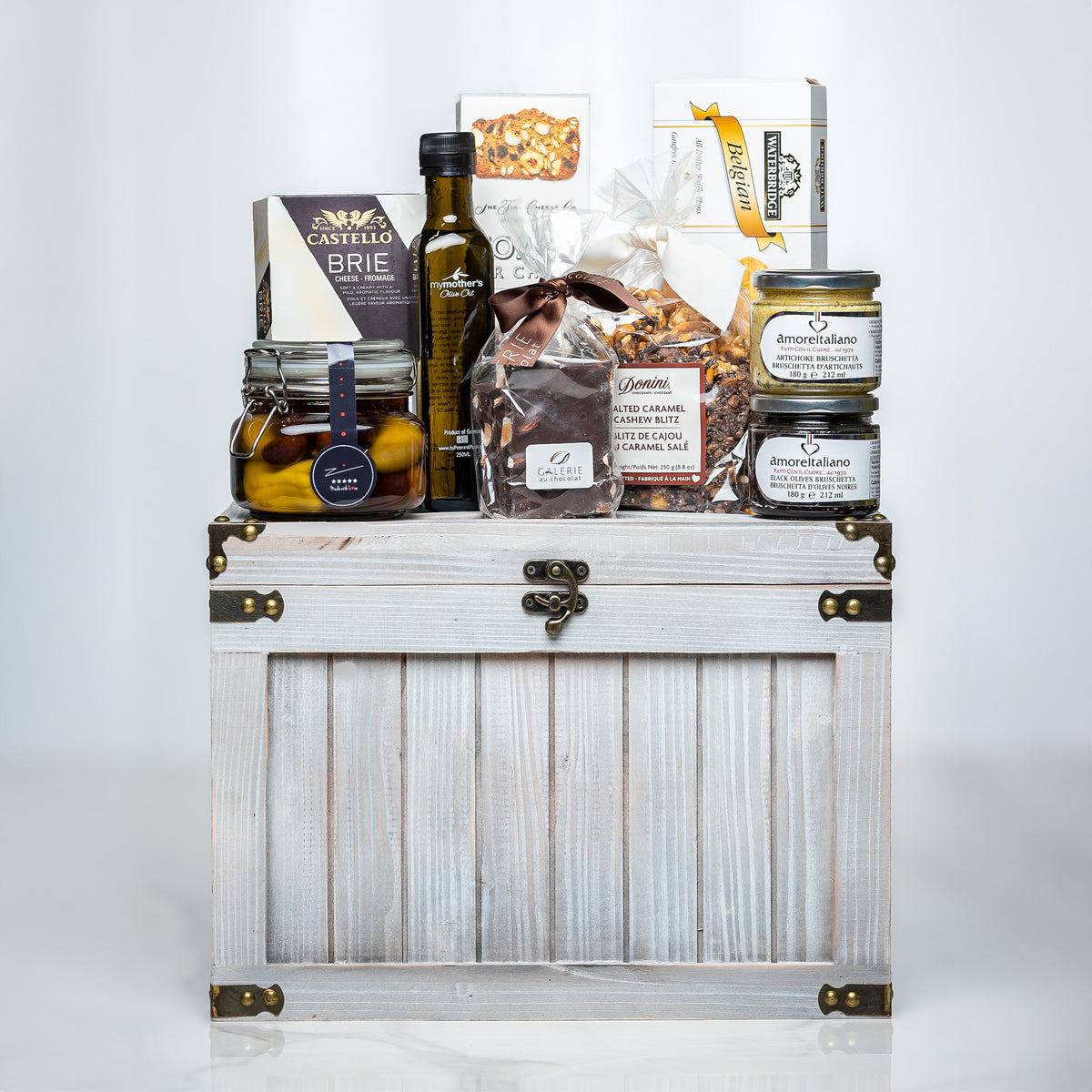 Ultimate Indulgence small white trunk with olive oil, preserves, chocolates and gourmet snacks