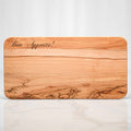 Olive wood footed serving board engraved with Bon Appetite
