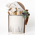 Winter Wonderland: a white tub with a silver pine tree design and a wooden lid, topped with a pinecone and filled with a Ferrero Rocher bar, Desobry biscuits, yogurt covered blueberries and caramel cashew popcorn