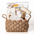 Woven Wonders Medium: a burlap woven basket with handles holding mini pretzels, fudge, fine French truffles, Inessence truffle crisps, caramel popcorn, jujubes and peanuts