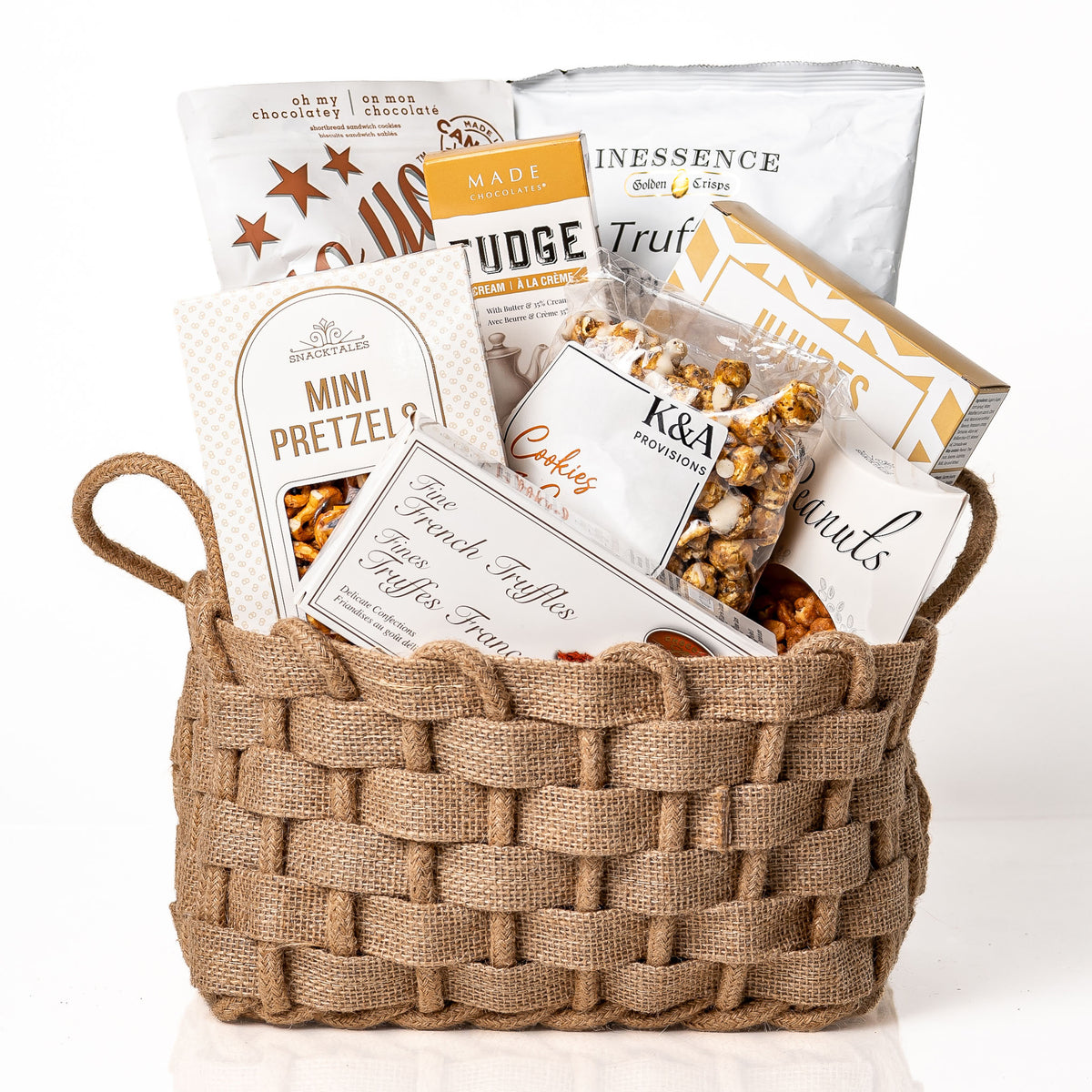 Woven Wonders Medium: a burlap woven basket with handles holding mini pretzels, fudge, fine French truffles, Inessence truffle crisps, caramel popcorn, jujubes and peanuts