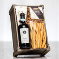 Box o Wine wooden crate with a bottle of red wine, grissini and Castello brie
