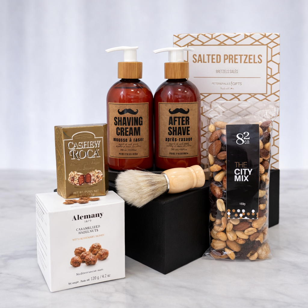 The Gentleman's Box close-up showing shaving cream, after shave, wooden shaving brush, City Mix nuts and Cashew Roca