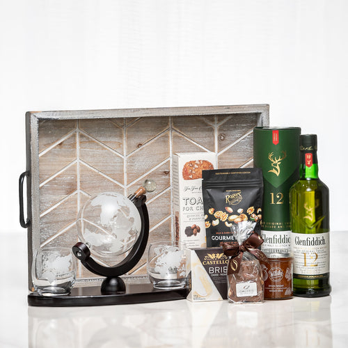 Globetrotter gift crate with a desk globe, whisky glasses, nuts and a bottle of Glenfiddich