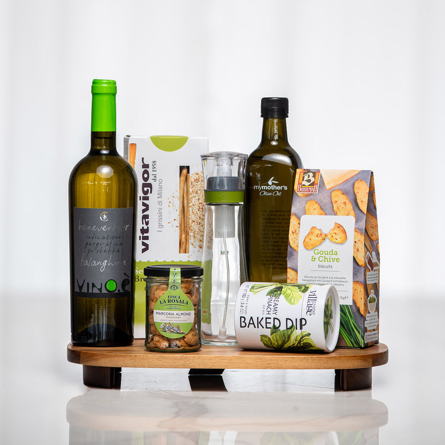 Graze and Gather gift board with white wine, olive oil, a vinaigrette shaker, dip and crackers