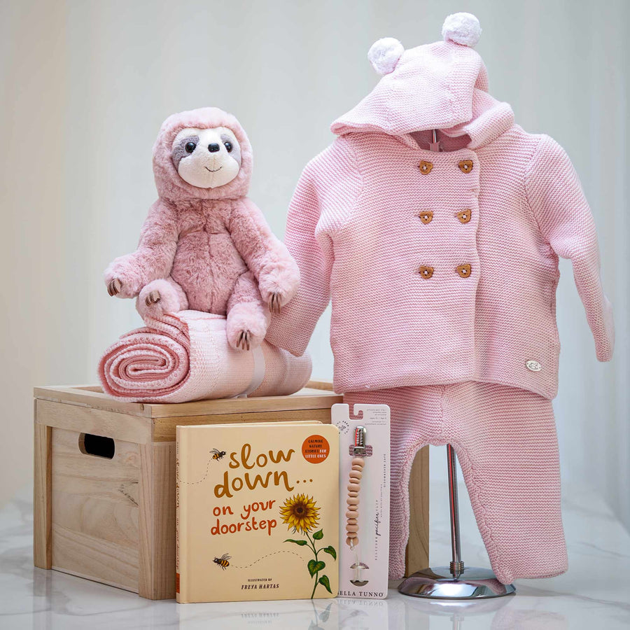 Slow Down Time girl's gift set with a pink knitted coat and trousers, a plush monkey and a keepsake book