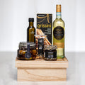 Our Signature Gift on a wooden riser with grissini, olives, preserves, olive oil and white wine
