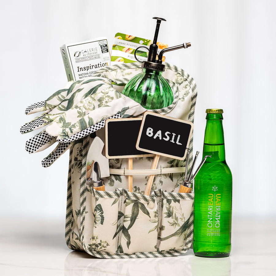 Plant & Pause gardening gift with a floral tool tote, stainless steel trowel and rake, chalkboard plant markers, gloves, glass plant mister, sparkling water and chocolate