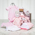 Little Star baby girl gift with pink onesies, a blanket and a plush kitten in a wooden crate
