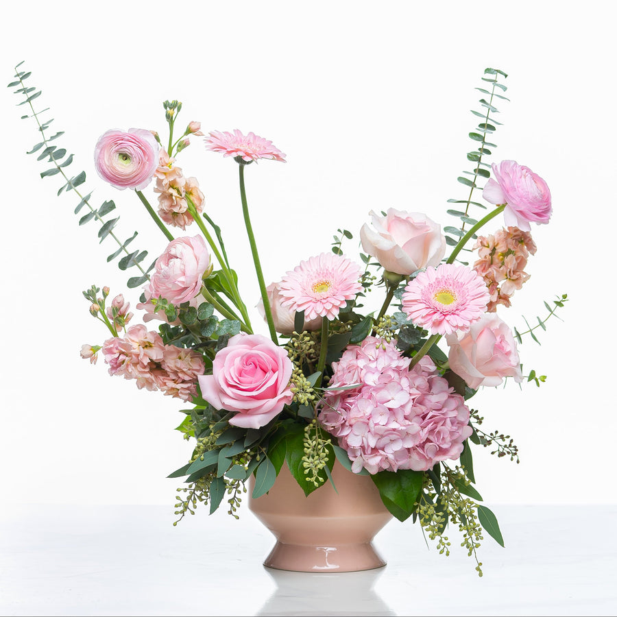Fancey Fleur arrangement of pink gerberas, ranunculus and hydrangea in a blush footed pot