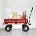 Red Wagon baby gift, a wooden pull wagon holding a white outfit, a keepsake box and a plush bear