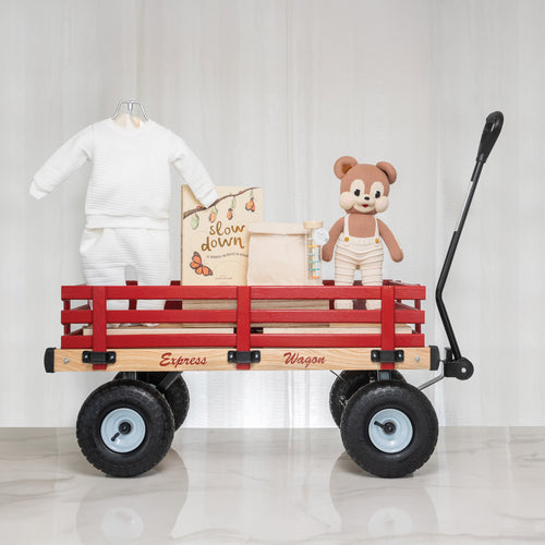Red Wagon deluxe baby gift, a wooden pull wagon with an outfit, keepsake box and a plush bear