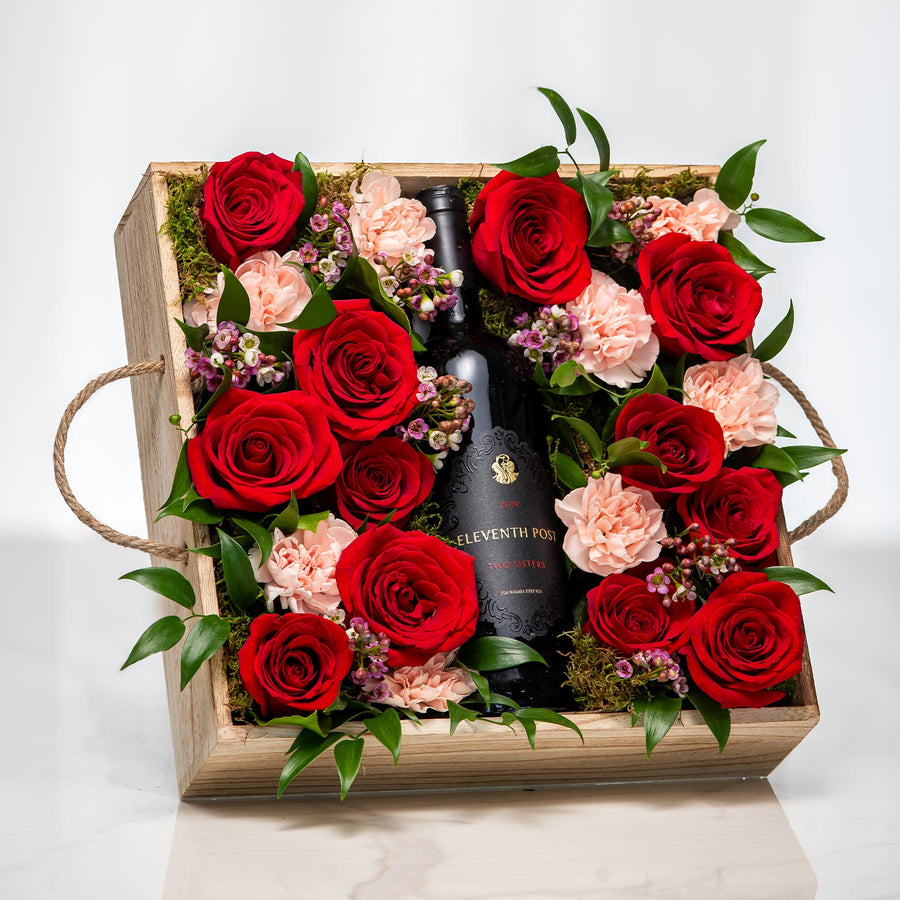 Rose Garden gift crate with a bottle of wine set among red and pink roses in a wooden tray
