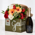 Tempting Trio gift with a Galup chocolate box, sparkling wine and an arrangement of gerberas and roses