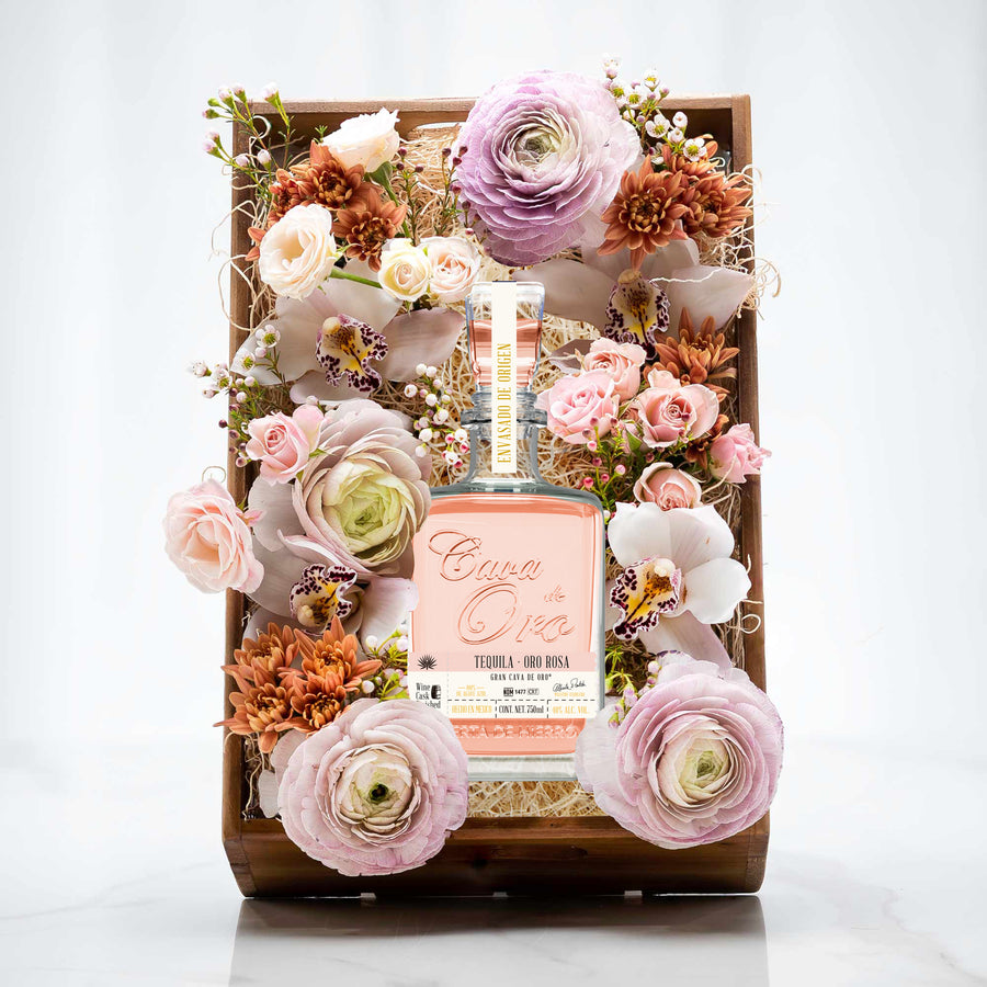 Tranquility and Tequila gift crate of pink and cream roses arranged around a bottle of Cava de Oro tequila
