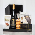 Uptown black gift box with a bottle of wine, pistachios, brie, crackers and fudge