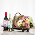 Vino and Vines gift with a bottle of red and a bottle of white wine and a bouquet of roses