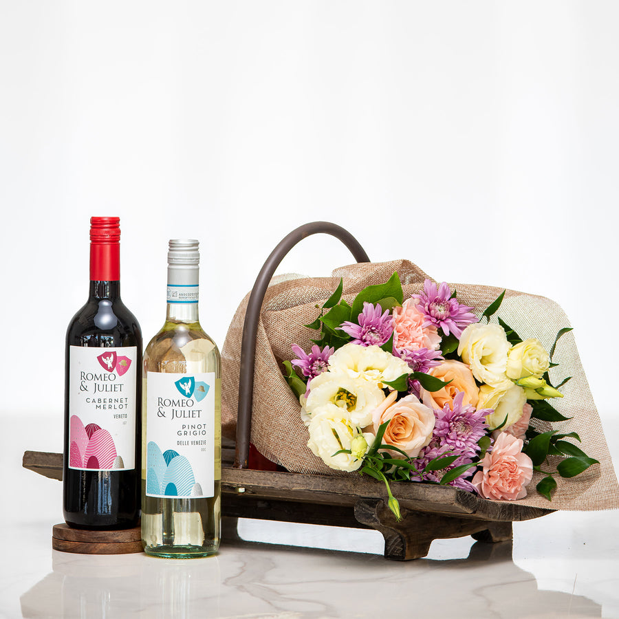 Vino and Vines gift with a bottle of red and a bottle of white wine and a bouquet of roses