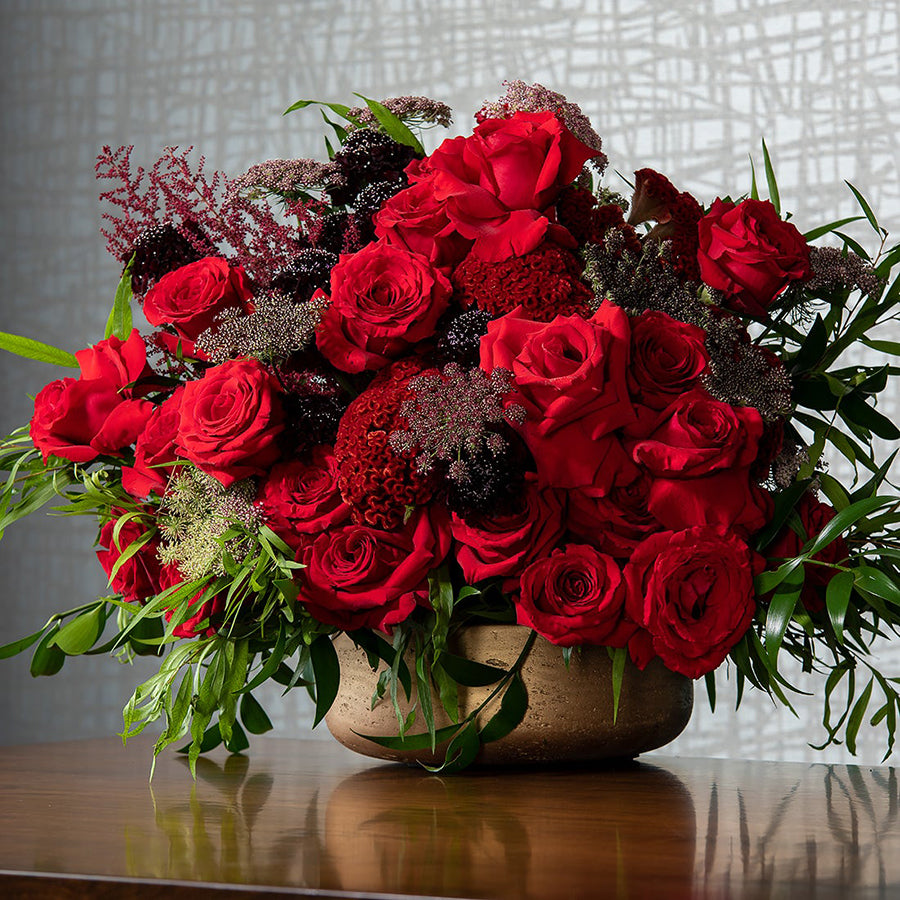 beautiful red floral arrangement in a gold base